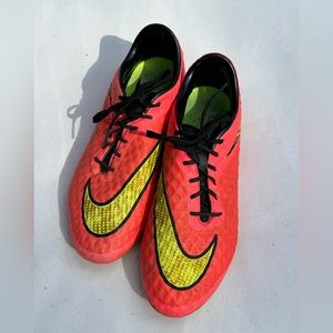 Bright pink and yellow Nike soccer cleats